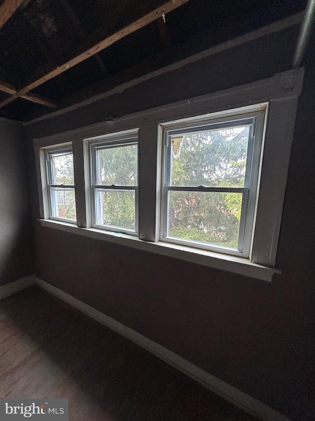 empty room with wood finished floors and baseboards