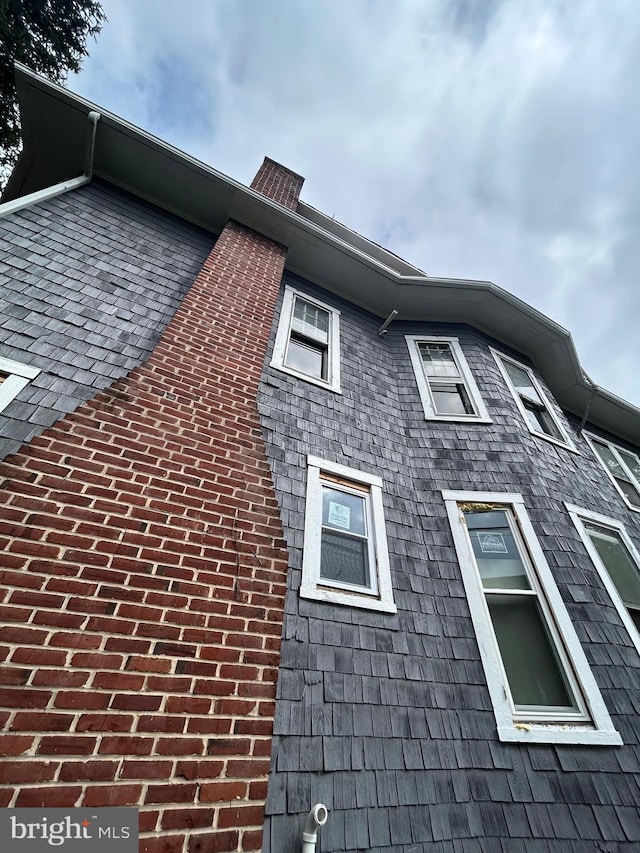 view of property exterior with brick siding