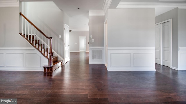 foyer entrance featuring dark wood-type flooring and crown molding