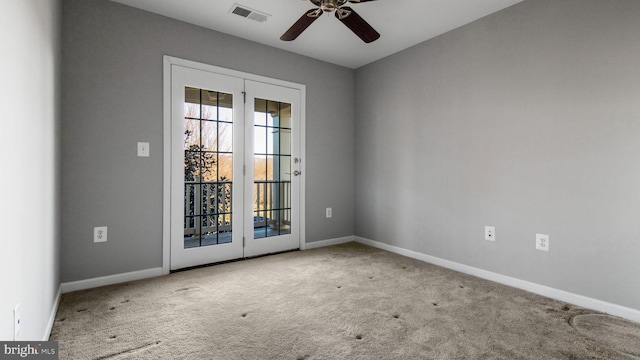 carpeted empty room featuring french doors and ceiling fan