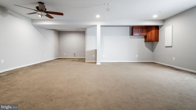 basement with ceiling fan and carpet flooring