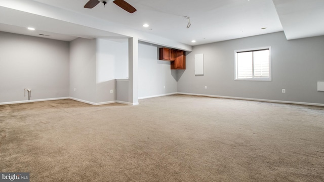 interior space with ceiling fan and light carpet