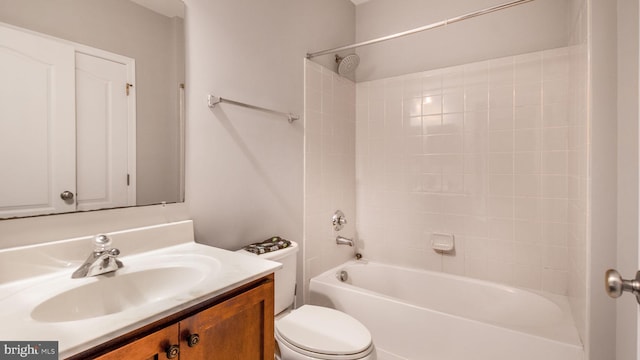 full bathroom featuring vanity, bathing tub / shower combination, and toilet