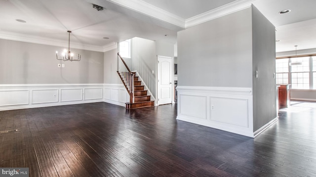 unfurnished room featuring ornamental molding, dark hardwood / wood-style flooring, and a chandelier