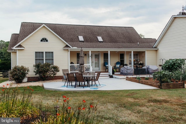 back of house with a patio area, a porch, and a yard