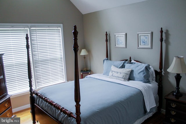 bedroom featuring wood-type flooring and vaulted ceiling