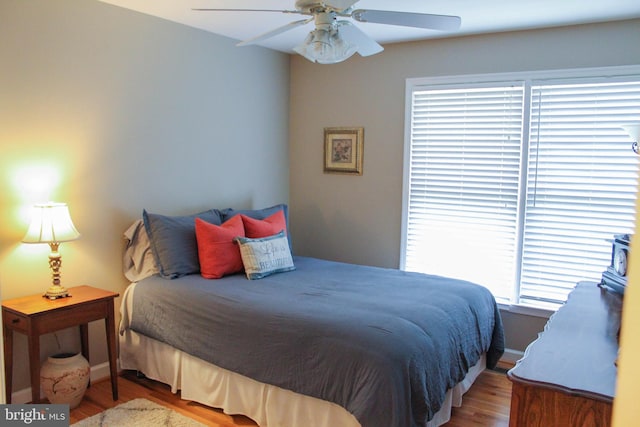 bedroom with ceiling fan and hardwood / wood-style flooring