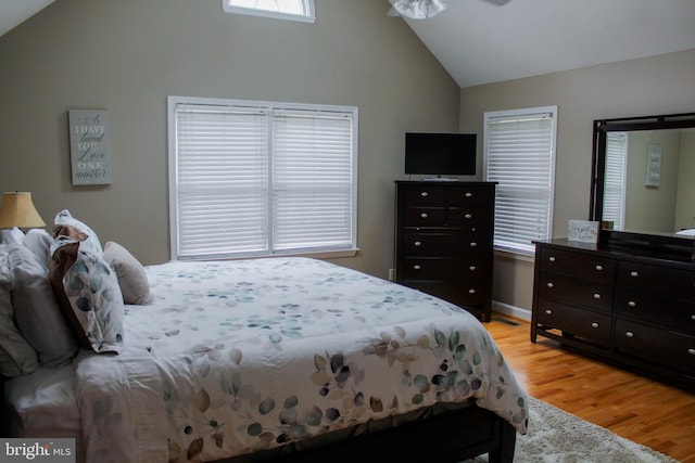 bedroom with light hardwood / wood-style floors and lofted ceiling