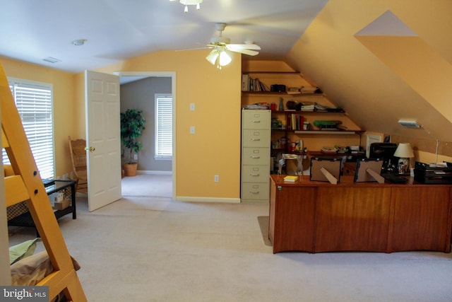 home office featuring vaulted ceiling, ceiling fan, and light colored carpet