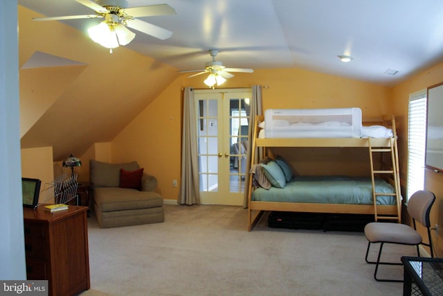 carpeted bedroom with french doors, lofted ceiling, and ceiling fan