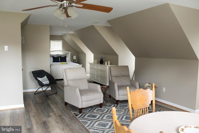 interior space featuring ceiling fan, lofted ceiling, and dark hardwood / wood-style flooring