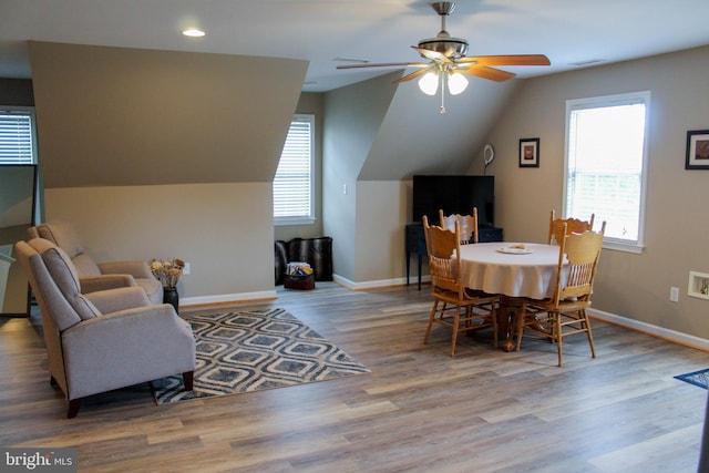 dining space with light hardwood / wood-style flooring, lofted ceiling, and ceiling fan