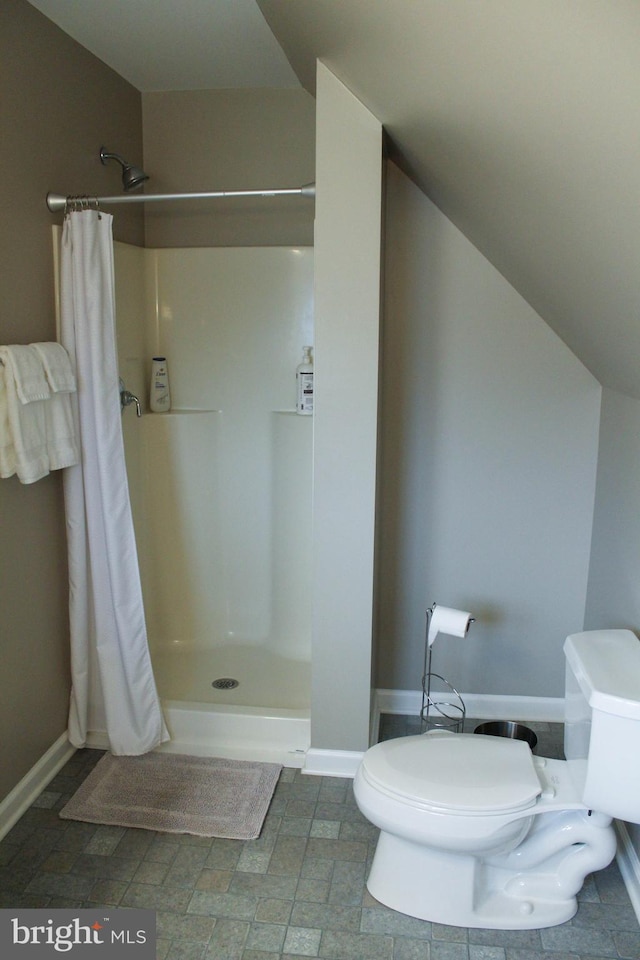 bathroom with a shower with curtain and toilet