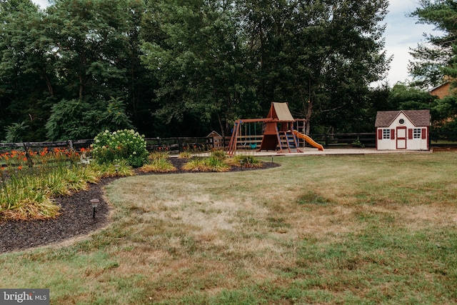 view of yard featuring a playground and a storage unit