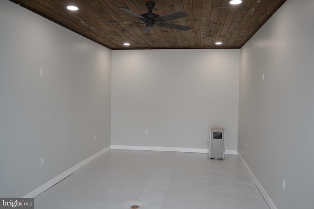 spare room with wooden ceiling, concrete floors, and ceiling fan