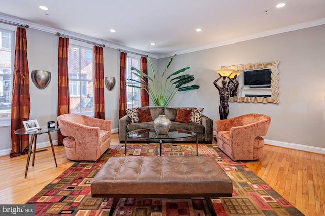 living room featuring ornamental molding, hardwood / wood-style flooring, and a wealth of natural light