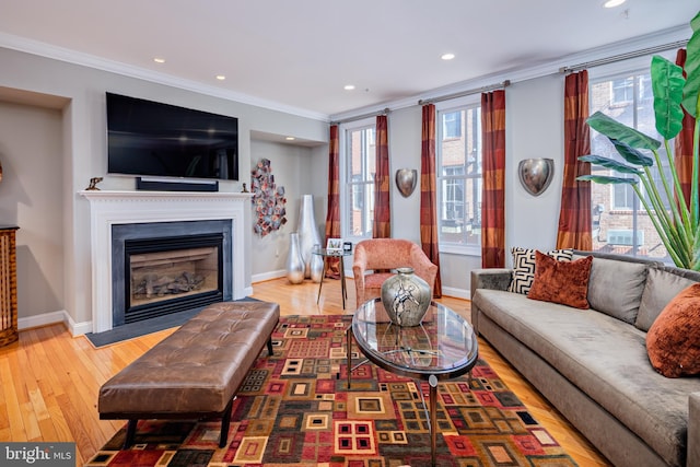 living room with ornamental molding, hardwood / wood-style floors, and a healthy amount of sunlight