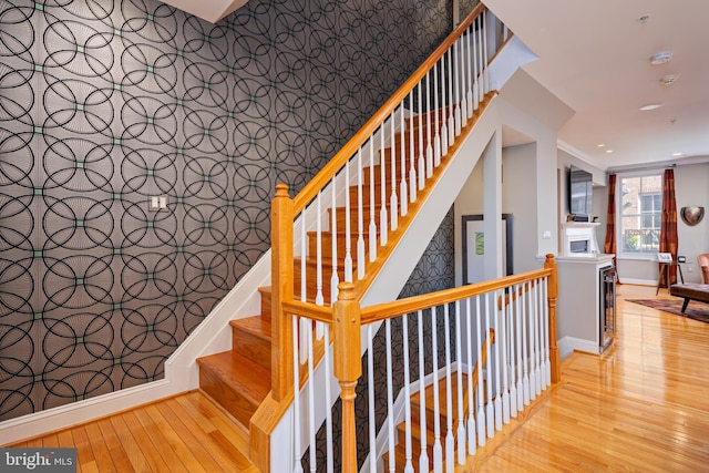 stairway featuring beverage cooler and hardwood / wood-style floors