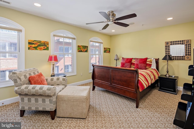 bedroom with multiple windows, carpet floors, and ceiling fan