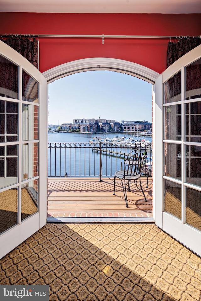 view of dock featuring a water view and a balcony