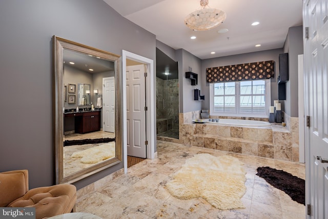 bathroom with vanity and independent shower and bath