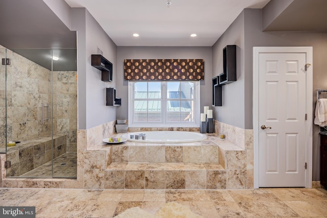 bathroom featuring independent shower and bath