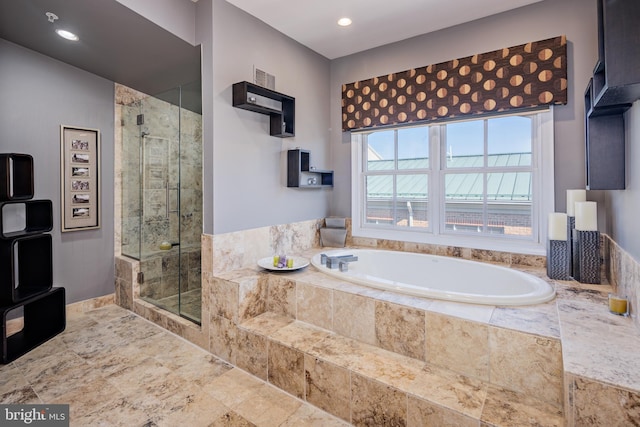 bathroom featuring separate shower and tub