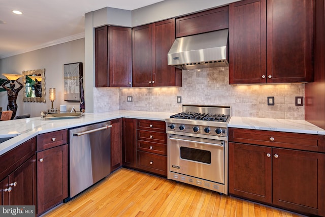 kitchen featuring light hardwood / wood-style flooring, stainless steel appliances, range hood, ornamental molding, and tasteful backsplash