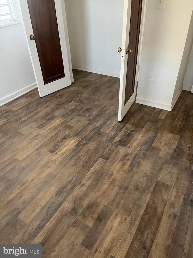 unfurnished bedroom featuring dark hardwood / wood-style floors