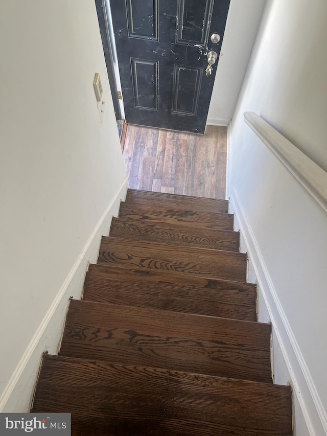 staircase featuring hardwood / wood-style floors