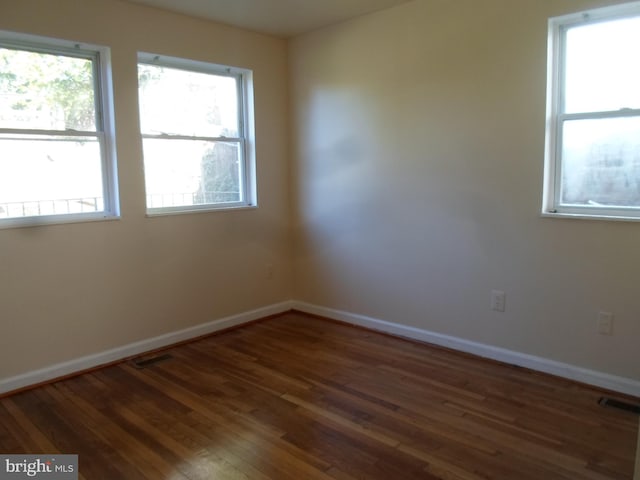 unfurnished room featuring dark wood-type flooring