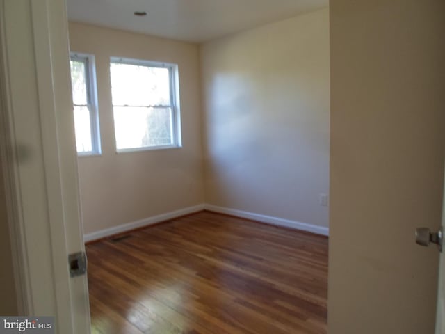 spare room featuring hardwood / wood-style floors