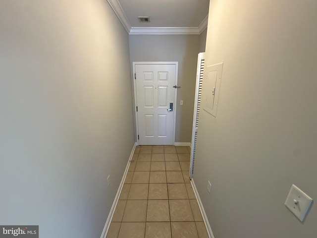 hall with electric panel, crown molding, and light tile patterned flooring