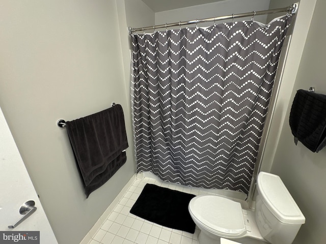 bathroom with toilet, tile patterned floors, and a shower with shower curtain