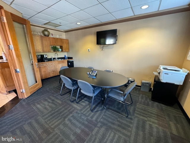 carpeted dining area featuring sink