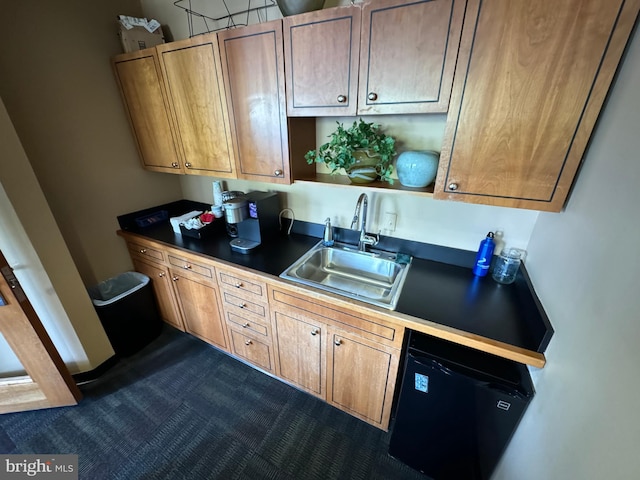 kitchen featuring dishwashing machine and sink