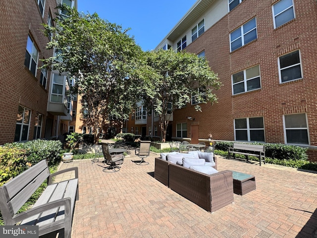 view of home's community with outdoor lounge area and a patio