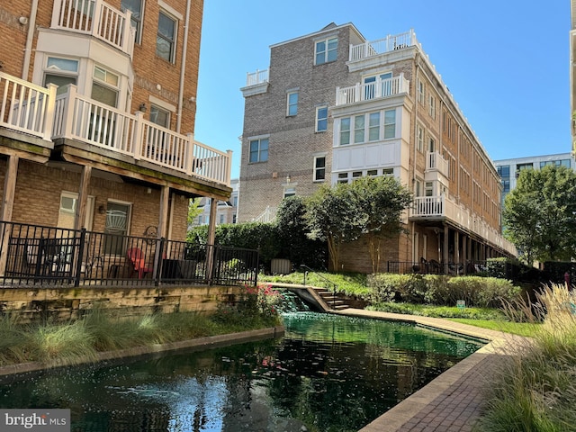 view of pool featuring a water view