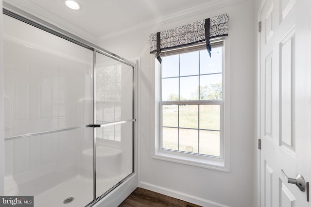 bathroom with ornamental molding, hardwood / wood-style floors, a healthy amount of sunlight, and an enclosed shower