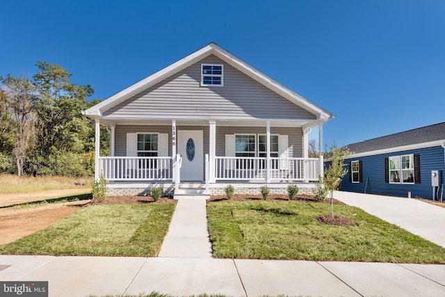 bungalow-style house with a porch and a front yard