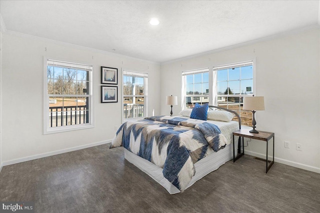 bedroom with multiple windows, ornamental molding, and a textured ceiling