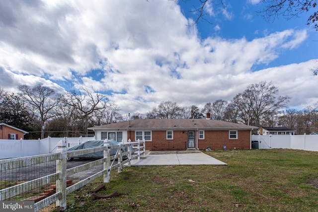 rear view of property with a patio and a yard