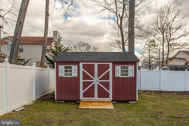 view of outbuilding with a lawn