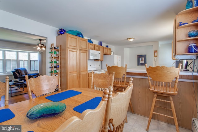 dining room with ceiling fan and a baseboard radiator