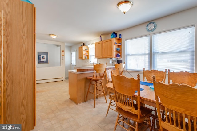 dining room featuring a baseboard radiator and sink