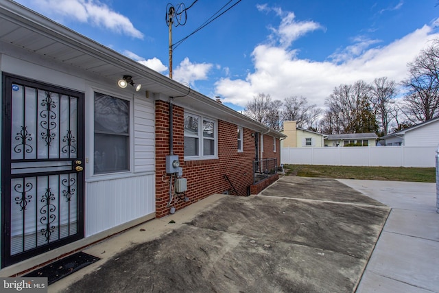 view of property exterior with a patio area