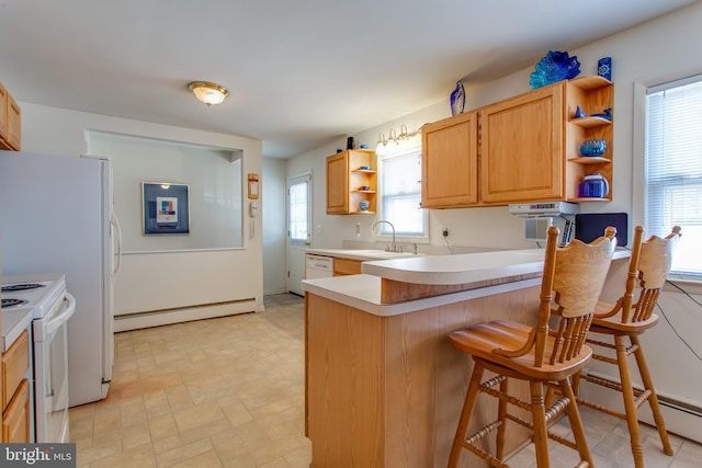 kitchen with white electric range oven, kitchen peninsula, sink, a kitchen breakfast bar, and a baseboard radiator