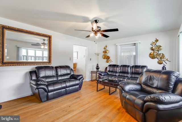 living room with light hardwood / wood-style floors and ceiling fan