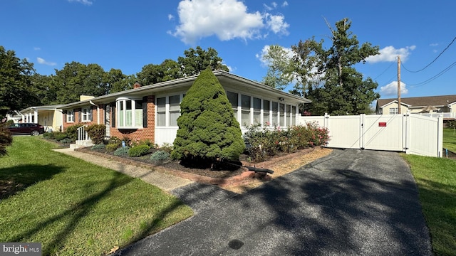 view of side of home with a yard