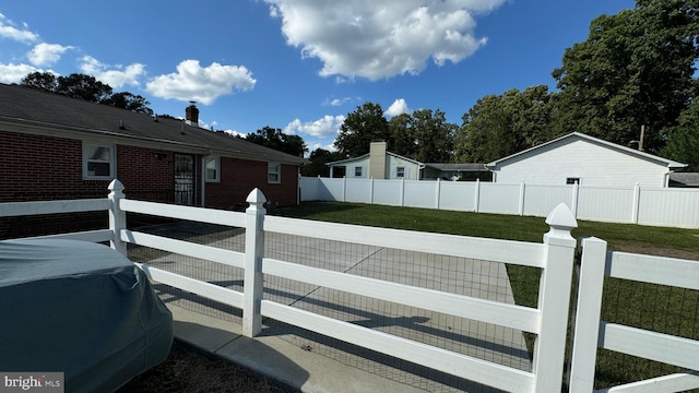 view of side of property with a lawn